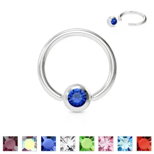 Piercing ze stali chirurgicznej - krążek z kolorowym kryształem w okrągłej oprawie - Wymiary: 1,2 mm x 10 mm, Kolor cyrkoni: Niebieski - B